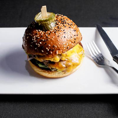 Black Diamond Burger, with cheese,  lettuce, tomato, onion, and house IPA pickles.