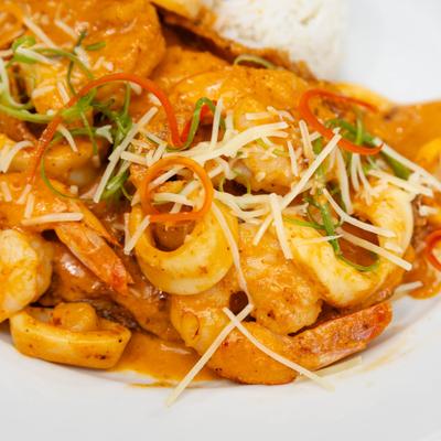 Fried fish filet topped with creamy seafood sauce and grated cheese.