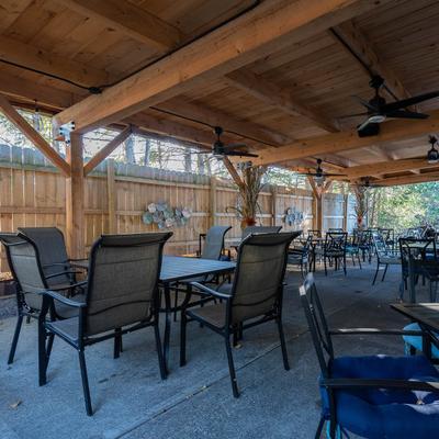 Outdoor covered patio, seating area.