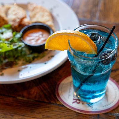 Irish egg rolls and a blueberry cocktail drink.