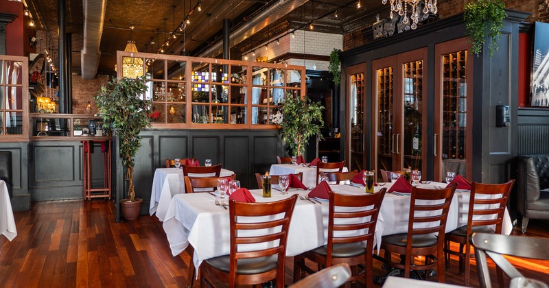 Interior, tables and chairs ready for guests, plant decorations