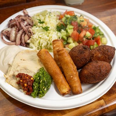 Fried Mix Platter kubbeh, soy meat cigars, salad, sauces and condiments.