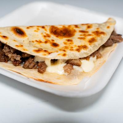 Large tortilla with grilled beef and cheese.