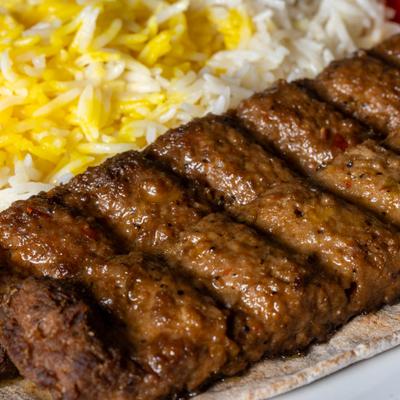 Ground beef kebab skewers and rice.