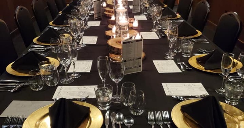 The boardroom set up for a small private event with a custom 7-course