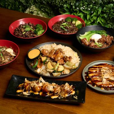 Assorted Asian dishes arranged on a wooden table.