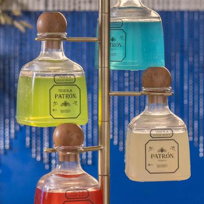 Four colorful tequila bottles on a stand.