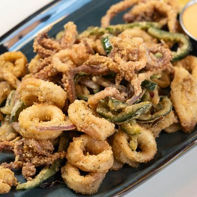Fried calamari with dip, closeup.