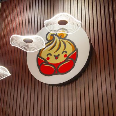 Restaurant's sign on the wall and lotus leaf pendant light hanging from the ceiling.