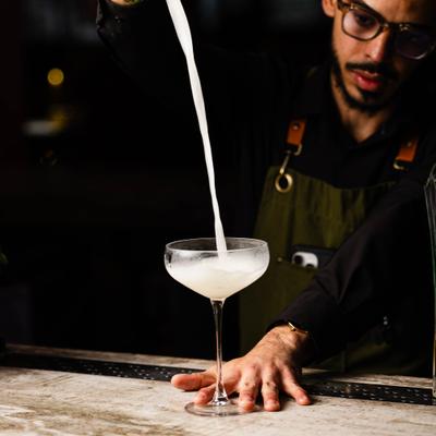 Bartender pouring s cocktail at the bar.