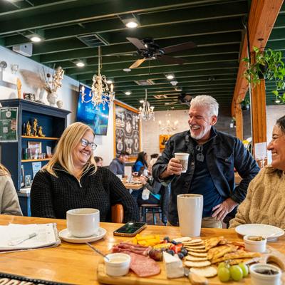 A group of happy people enjoying a conversation at a bar counter.
