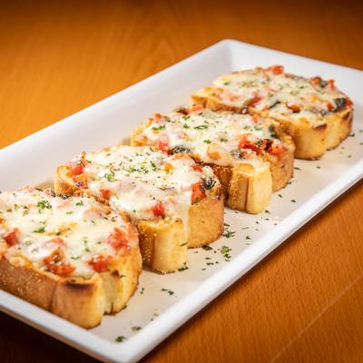 Bruschetta, with basil, garlic, tomatoes, and melted mozzarella.