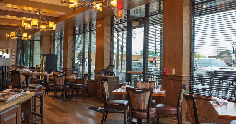 Interior, dining area, tables for four, restaurant entrance, large windows with blinds