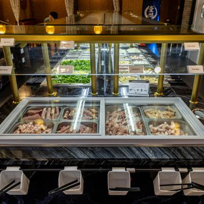 Interior featuring a sleek, black marble buffet counter with a dedicated meat display.