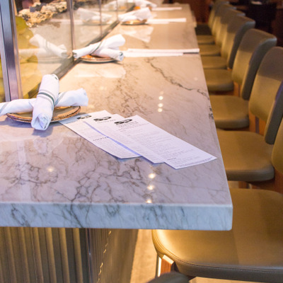 view of marbled countertop with menus at oyster bar