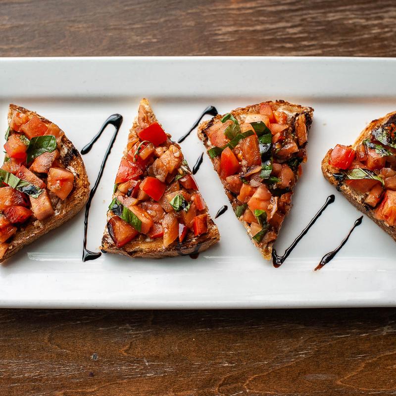 Bruschetta, roma tomato, basil, goat cheese, balsamic reduction, macrina crostini - GF photo