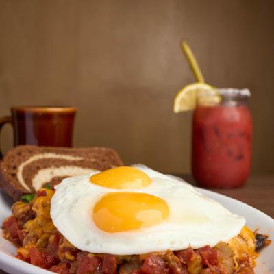 Corned Beef Hash with two sunny side up eggs and marble rye toast.