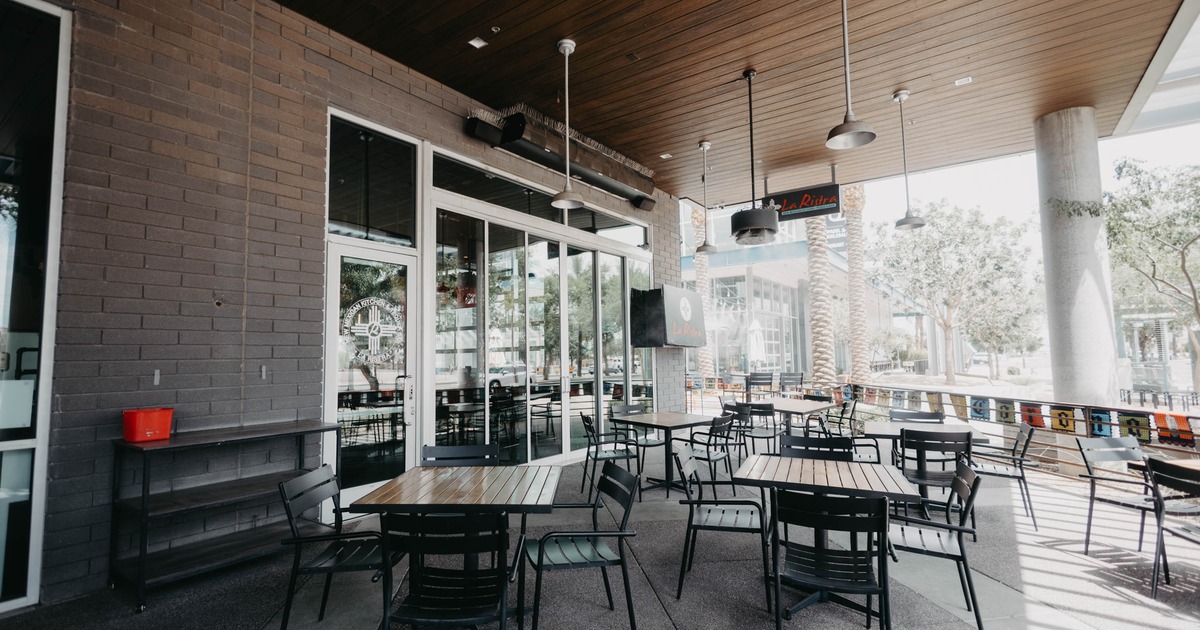 Exterior, covered patio with chairs and tables