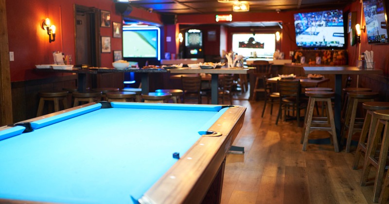 Interior, pool table with dining area in the background