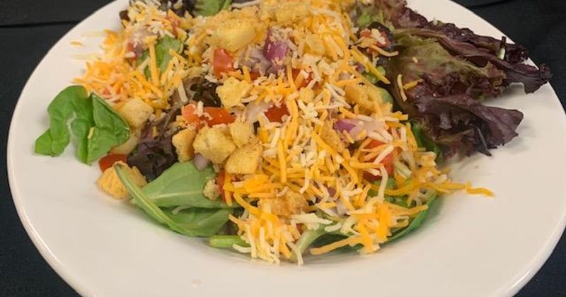 Salad with shredded cheese on top