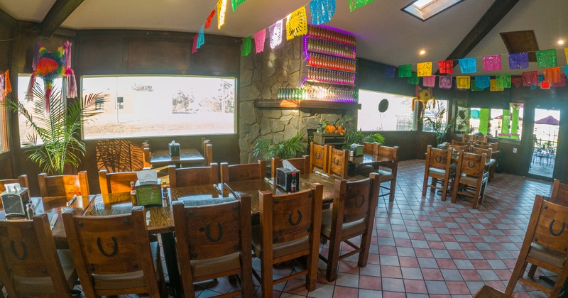 Mexican-style dining area with wooden tables and chairs
