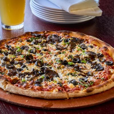 Veggie pizza with olives, mushrooms, and scallions.