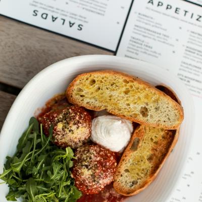 Meatballs, with ricotta cheese, tomato sauce, parmesan, arugula and grilled bread