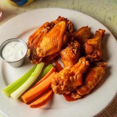Wings with celery, carrot and sauce for dipping.