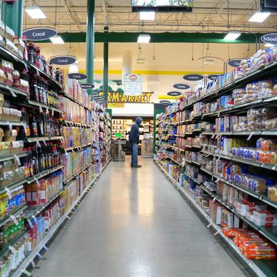 Grocery store aisle with shelves of packaged food items.