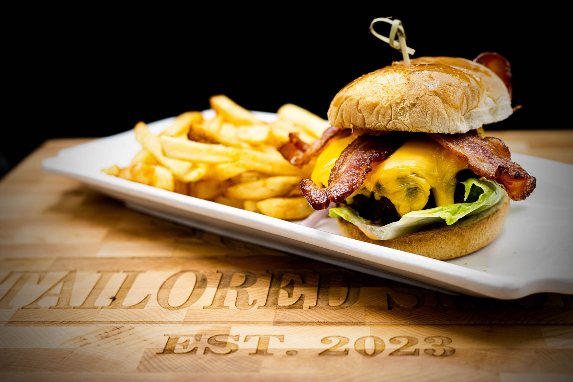 A burger and fries from Tailored Smoke Cigar Lounge