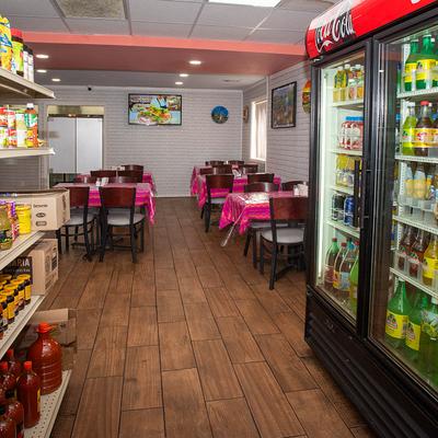 The interior space, refrigerators, tables, and chairs.