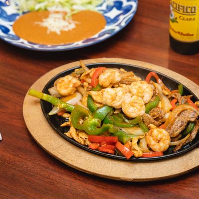 MIxed meat and seafood fajitas, served on the table.