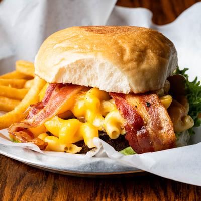 Burger with bacon, mac and cheese, lettuce, pickles, and mayo.