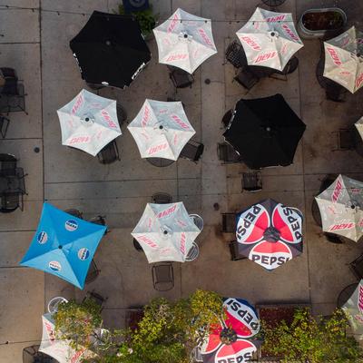 Overhead view of outdoor patio with umbrellas and sunshade.