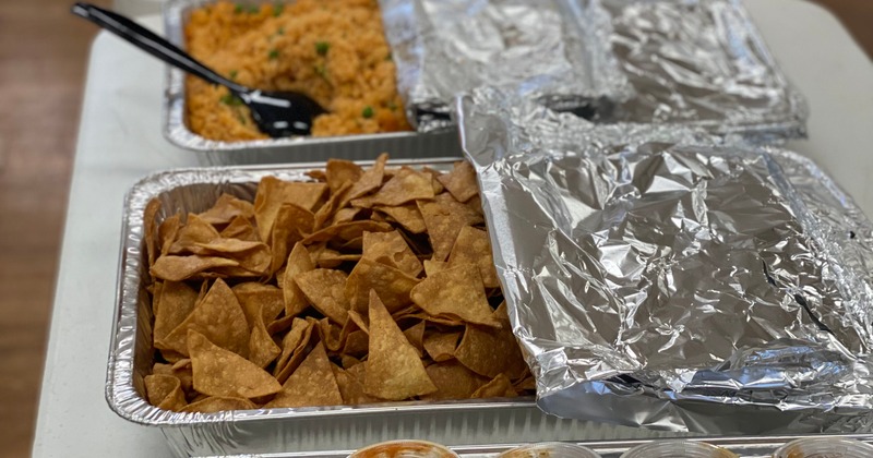 Catering food trays lined up on a table