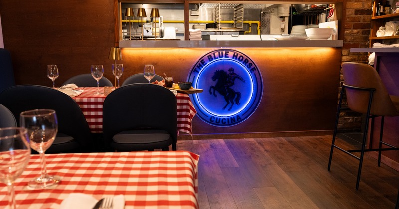 Dining space, tables with red and white tablecloths and chair