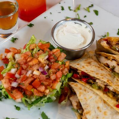 Quesadilla served with pico de gallo, avocado and sour cream.