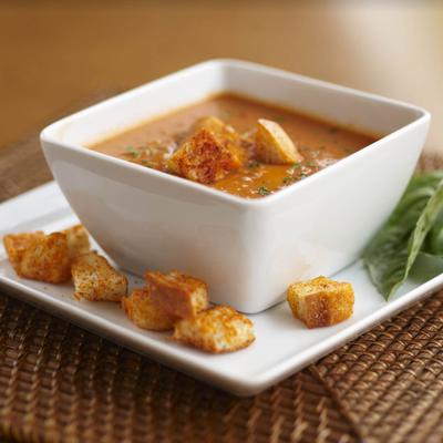 A bowl of soup, with croutons.