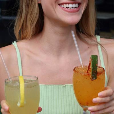 A person holding drinks.