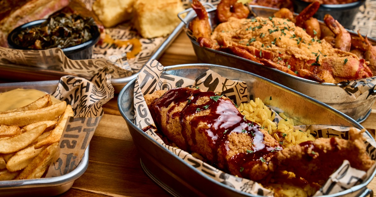 Barbecue platter with fried shrimp, ribs, rice, and sides