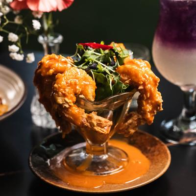Crispy fried shrimp served in a glass bowl with greens.