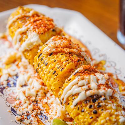 Roasted corn on the cob, mayo, white cheese & tajin