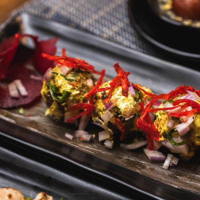 Meatballs, in malai sauce, herbs, and spices.