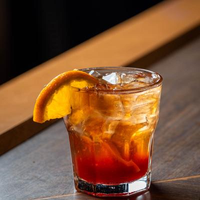 Old Fashioned garnished with a slice of orange.