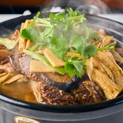 Steaming Braised Beef Brisket with Bean Curd Sticks in Clay Pot.