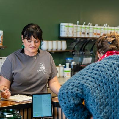 Bartender taking order from the guest at the bar.
