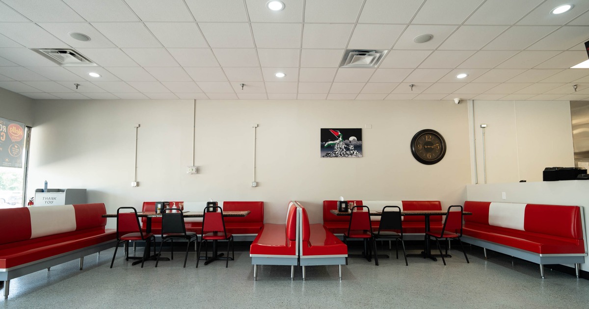 Interior, open space dining area, padded benches with tables and chairs