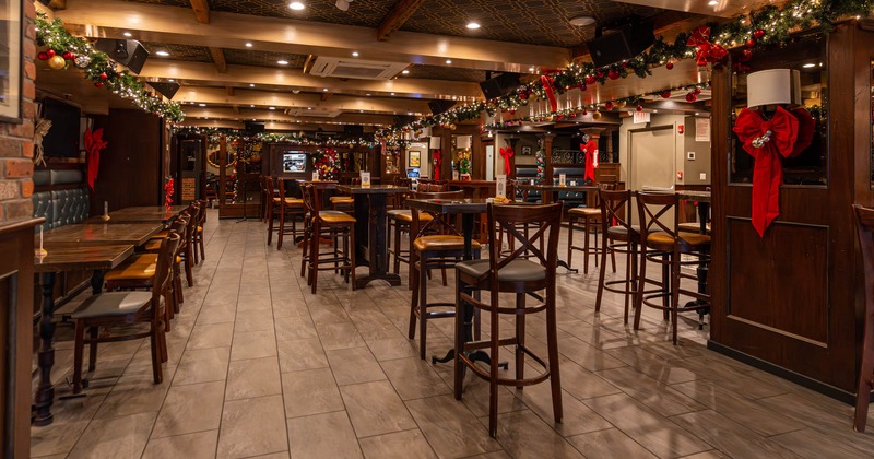 Interior, high tables with bar stools, banquette bench with tables and chairs, tile flooring