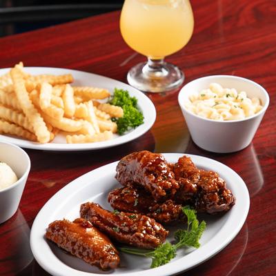 BBQ chicken wings, with a side of fries, and mac and cheese.