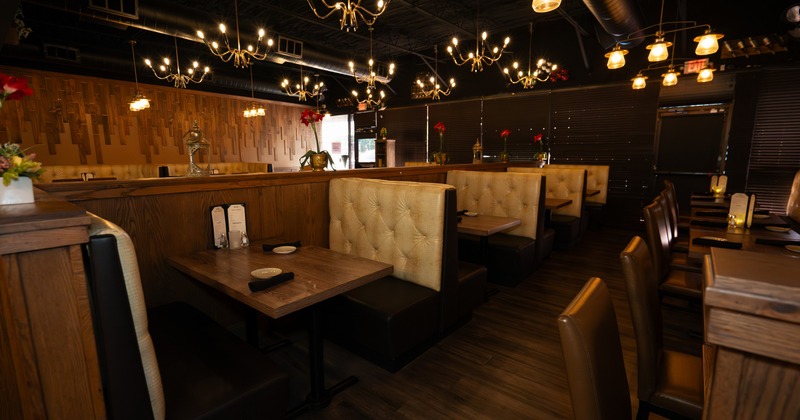 Booth seating area with tables and warm lighting